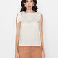 white sleeveless blouse with bow detail on shoulder styled with brown pants