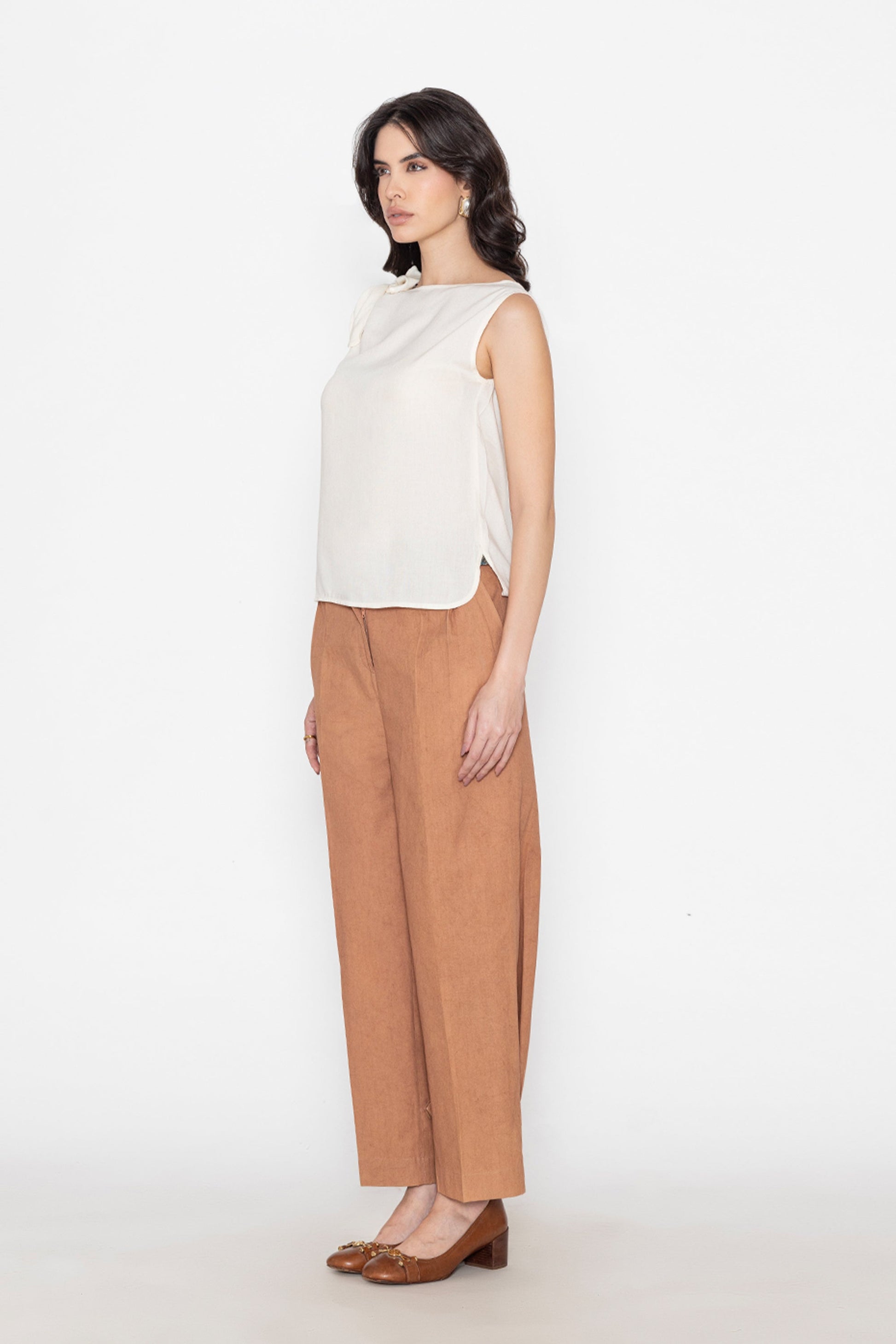 white sleeveless blouse paired with brown wide-leg pants and brown flats