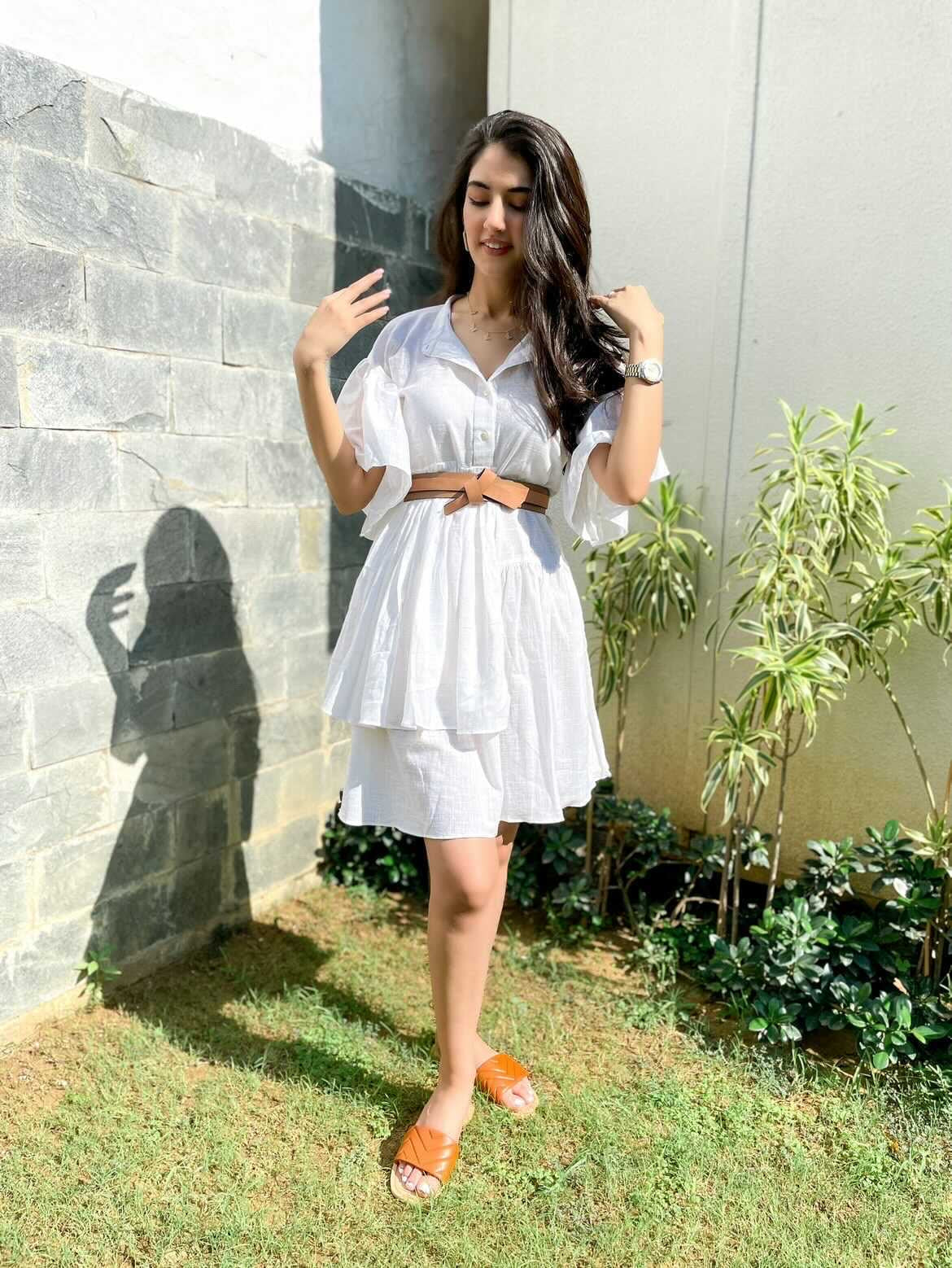 Stylish white summer dress for women by Stylera, featuring a belt and elegant sleeve design