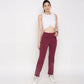 Model wearing a white twisted crop top paired with burgundy workout pants for a stylish look