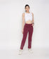 Model wearing a white twisted crop top paired with burgundy workout pants for a stylish look