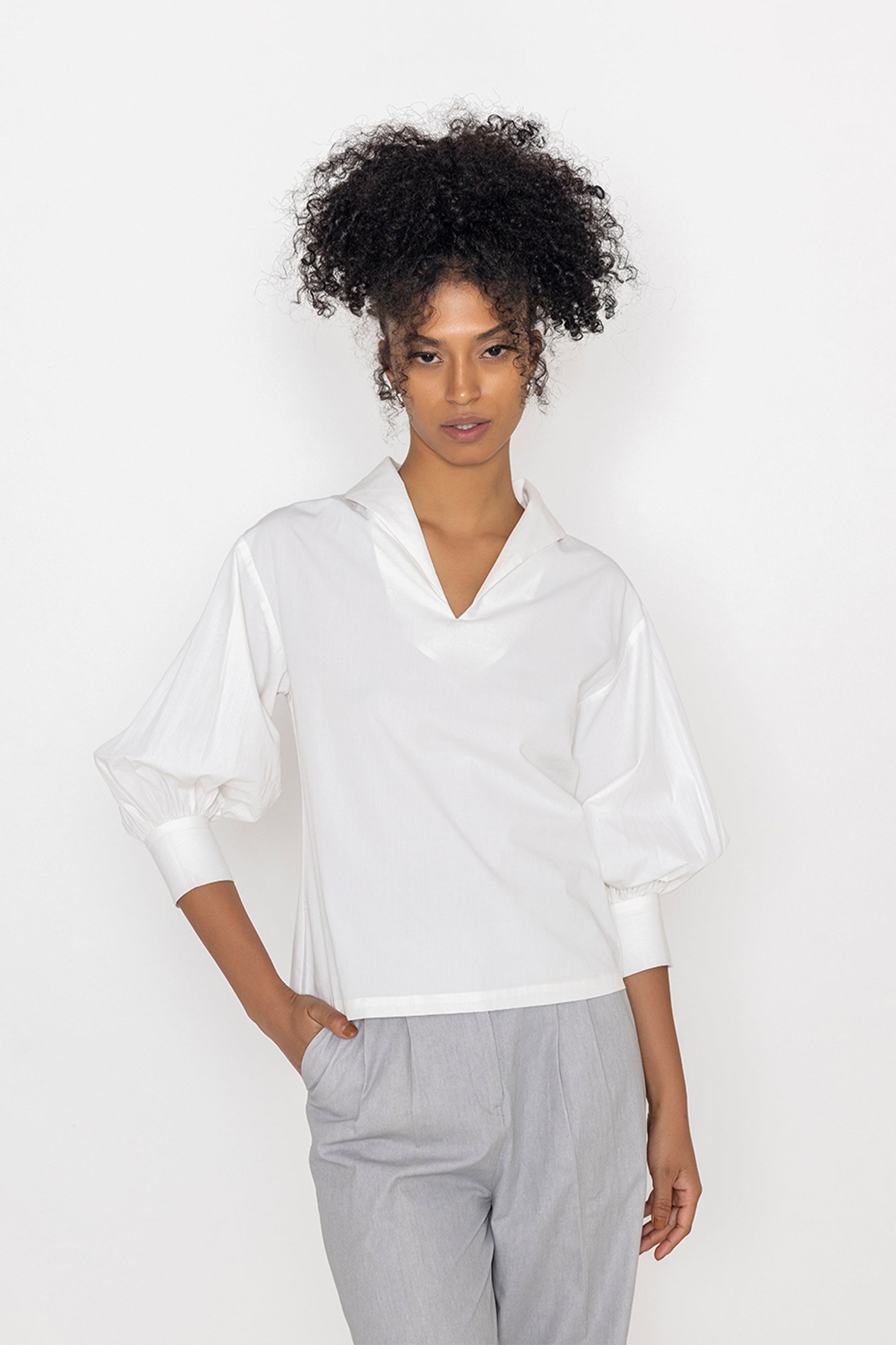 Stylera white v neck blouse for women with three quarter puff sleeves and relaxed fit