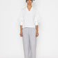 Stylera white v-neck blouse for women with puffed sleeves paired with light gray pants