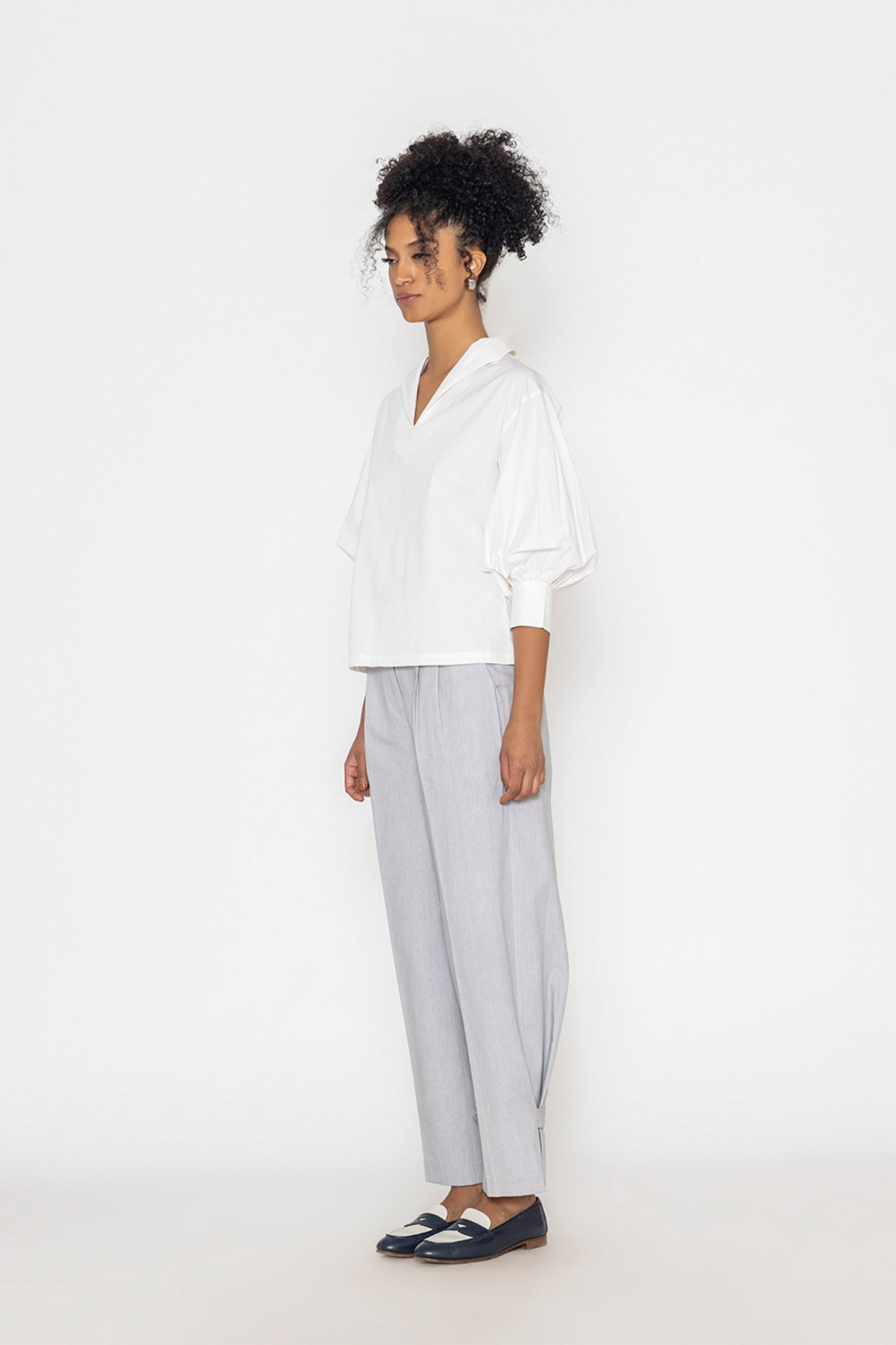 Stylera white v-neck blouse for women with balloon sleeves paired with light gray pants