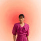 Stylera woman wearing a wine embroidered scalloped top with puff sleeves and ruffle details