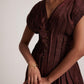 Stylera wine red v neck dress with button detailing and pleated design on model