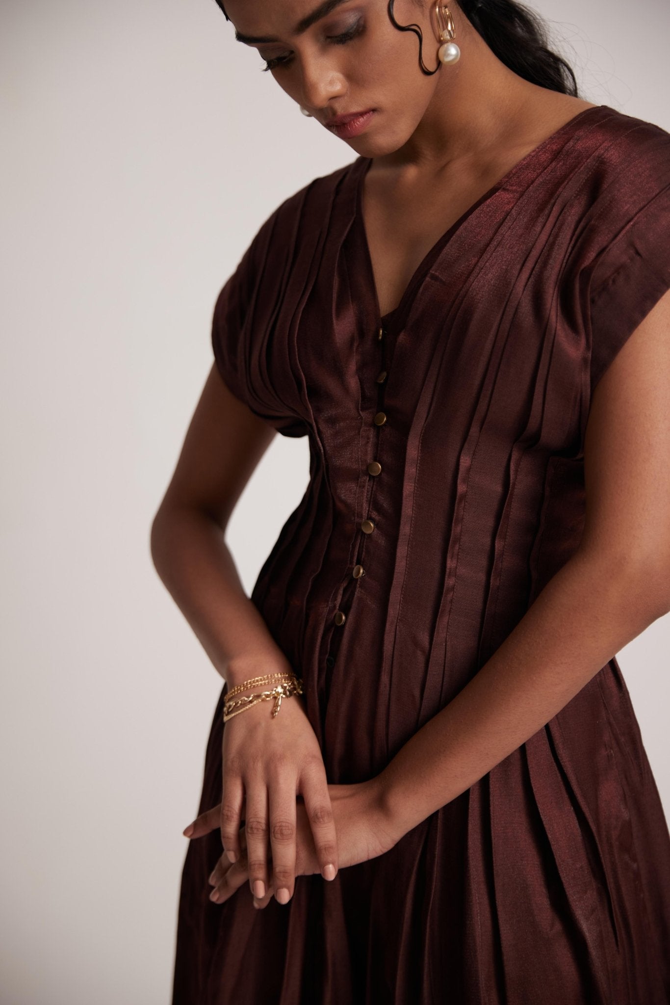 Stylera wine red v neck dress with button detailing and pleated design on model