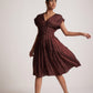 Stylera wine red v neck dress with pleated design worn by woman with heels