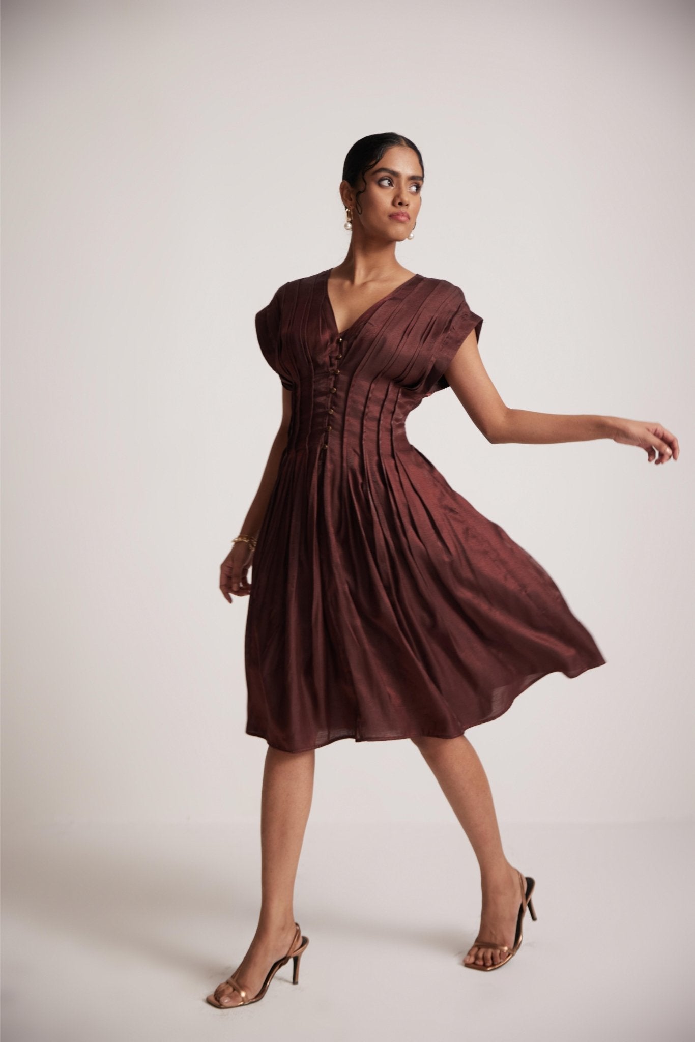 Stylera wine red v neck dress with pleated design worn by woman with heels