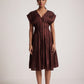 Stylera wine red v neck dress with pleated skirt and buttoned front worn by model