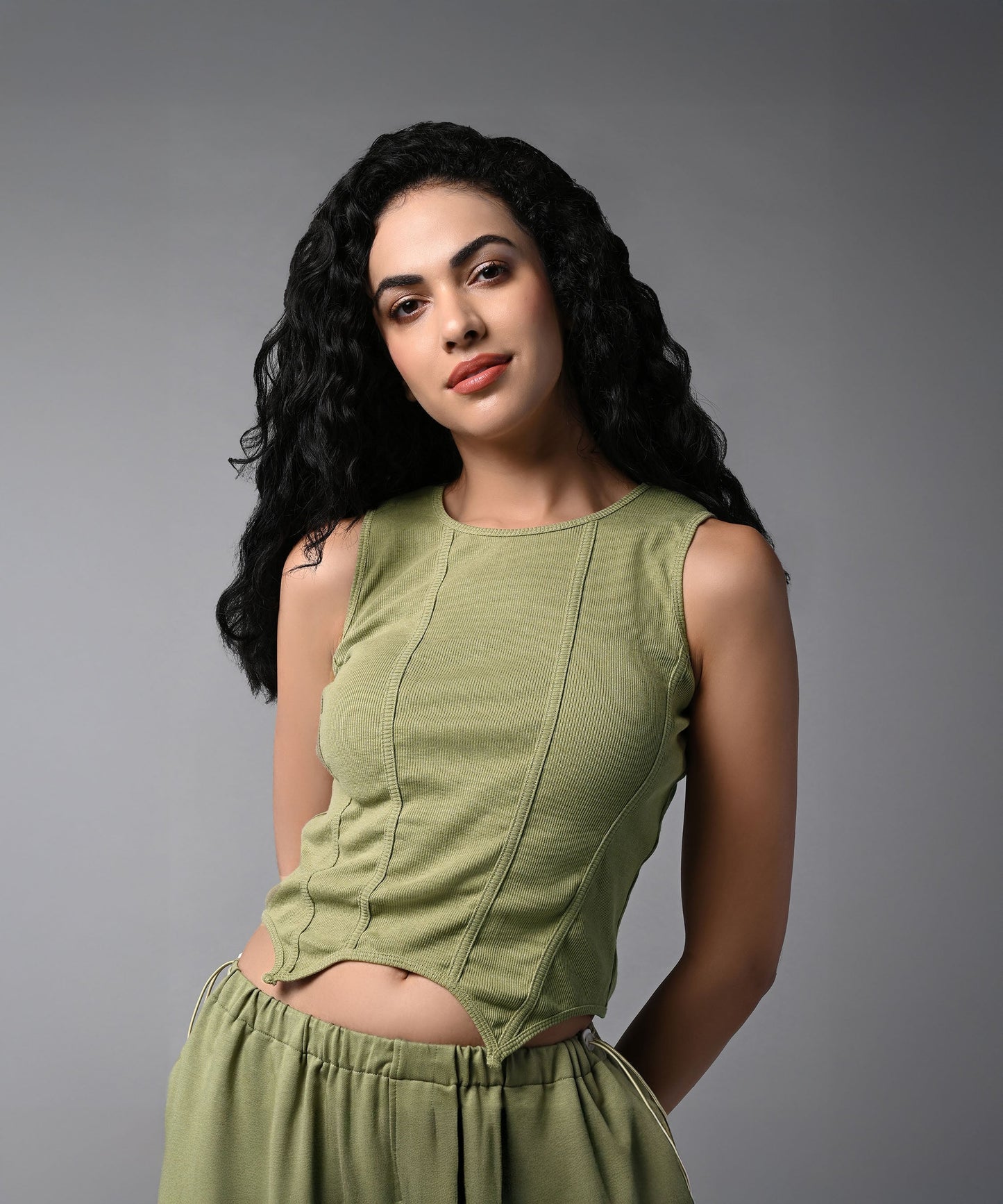 Model wearing women's cargo parachute pants with crop top in olive green for a trendy look
