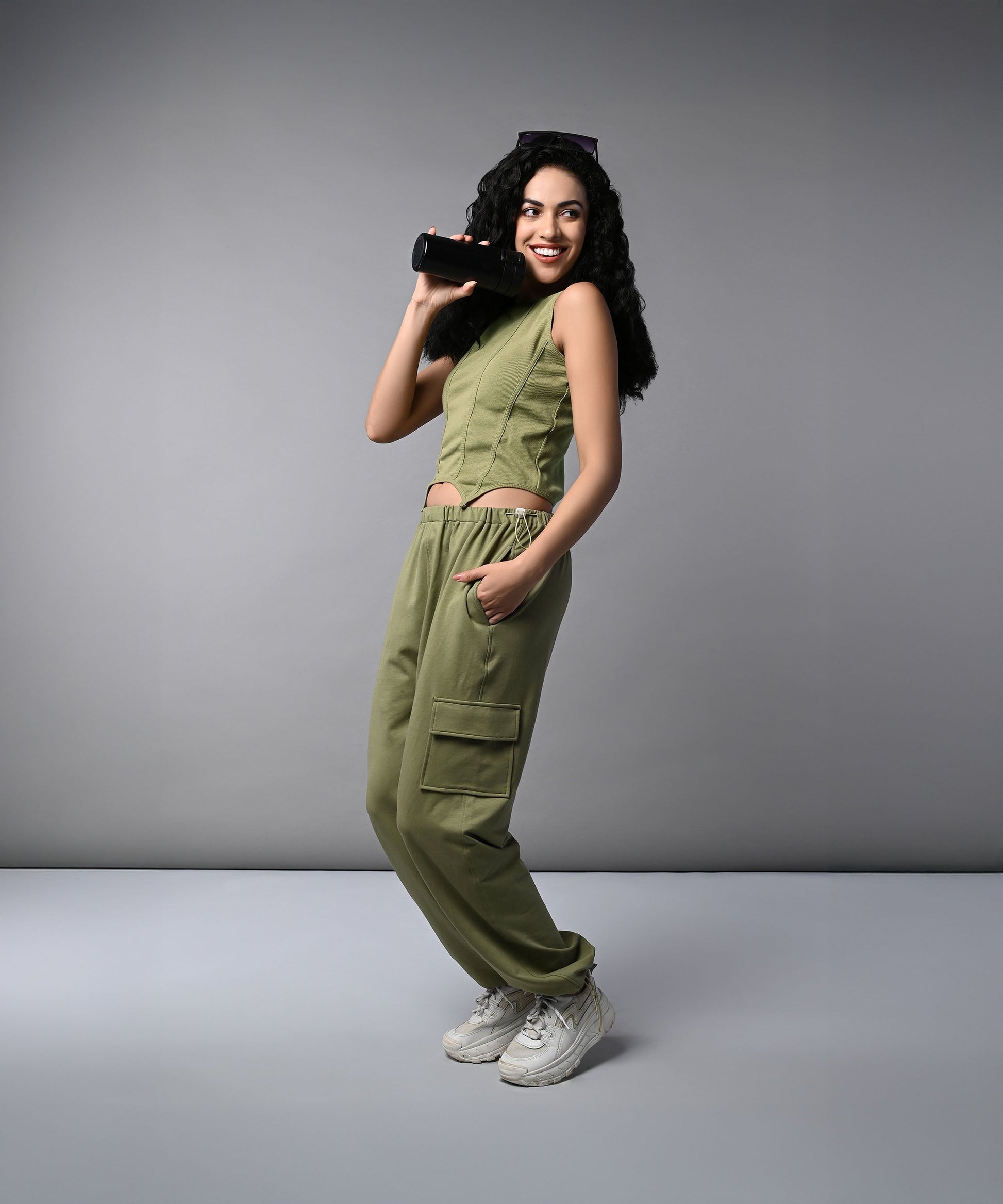 Stylish woman wearing women's cargo parachute pants with crop top in olive green, perfect for casual outings