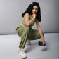 Model wearing women's cargo parachute pants with crop top in olive green, styled for casual fitness looks