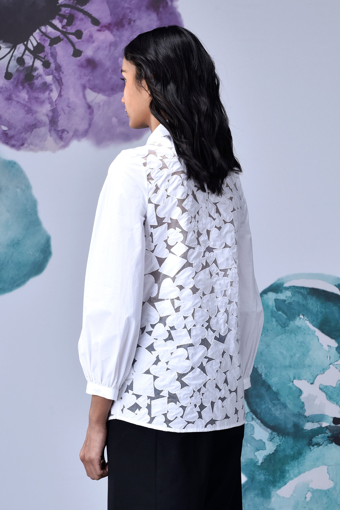 Rear view of model wearing Stylera women's casual chic white shirt with floral lace cutout back