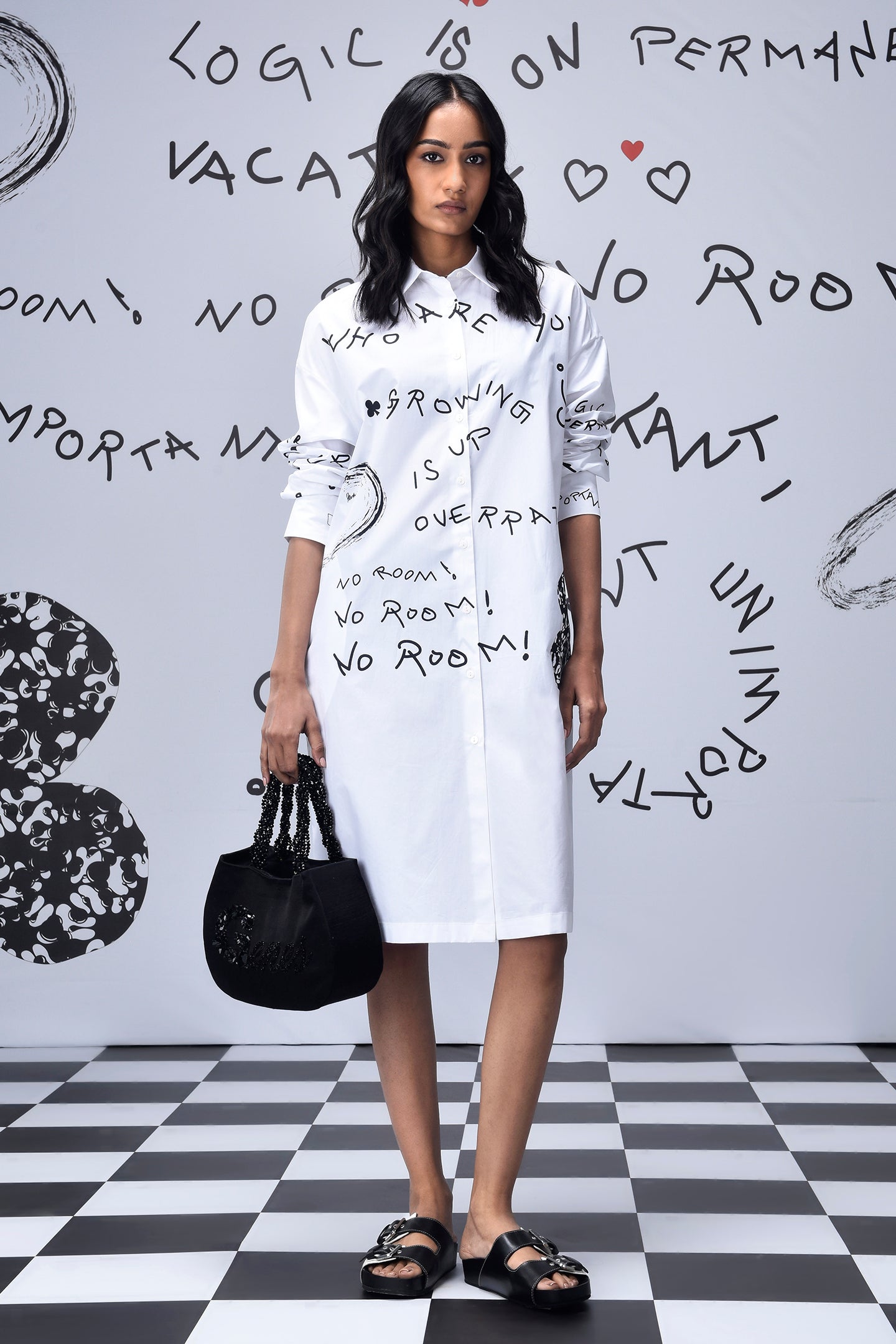 Model wearing Stylera women’s casual shirt dress with print white knee length shirt dress with black script