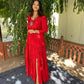 Model wearing a vibrant red women's elegant long dress with tiered design and a thigh slit