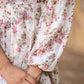 Close-up of a women's floral dhoti style dress showing intricate floral patterns and puffed sleeves