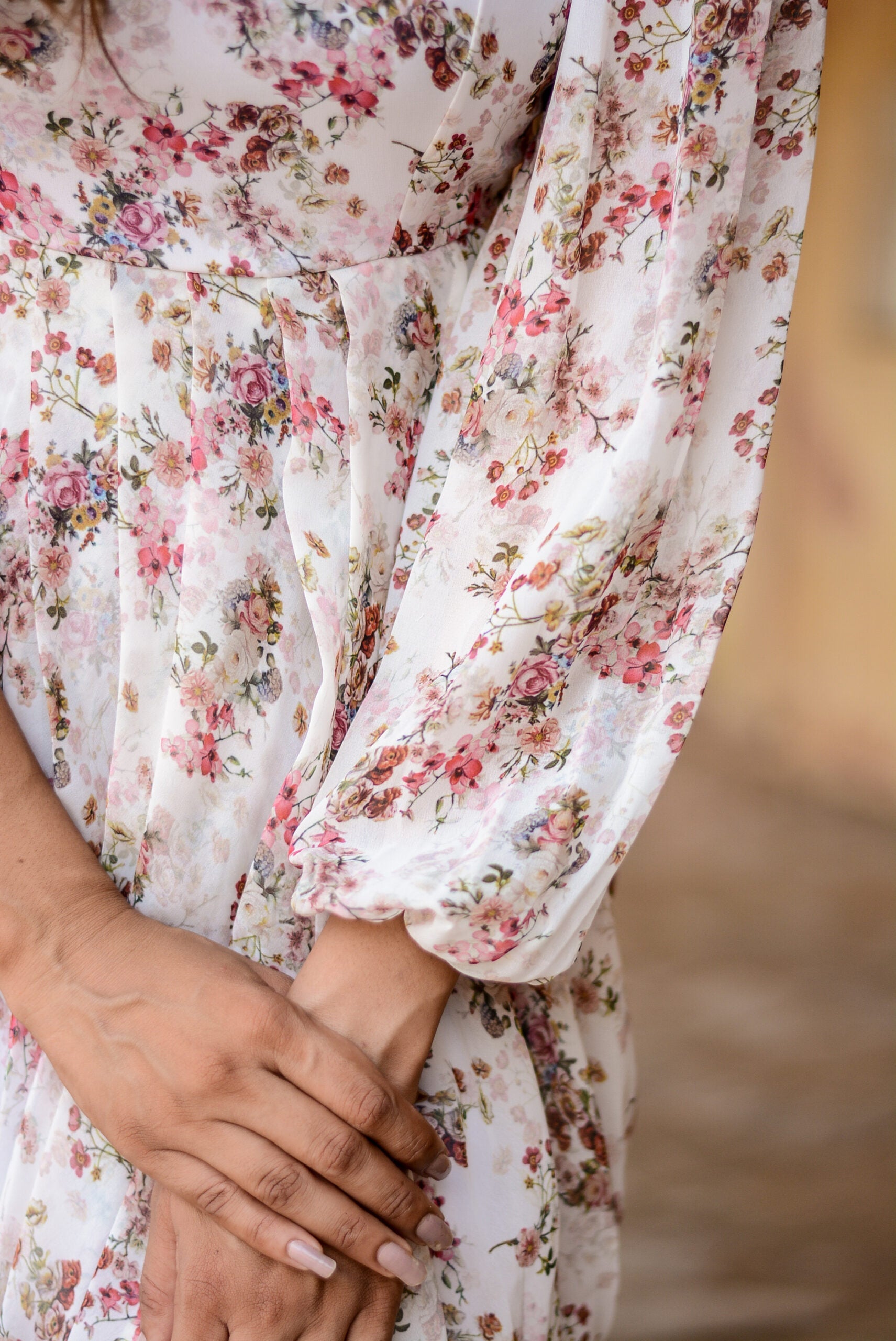 Close-up of a women's floral dhoti style dress showing intricate floral patterns and puffed sleeves