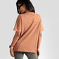 Back view of woman wearing womens graphic oversized mocha tee paired with gray jeans and sunglasses