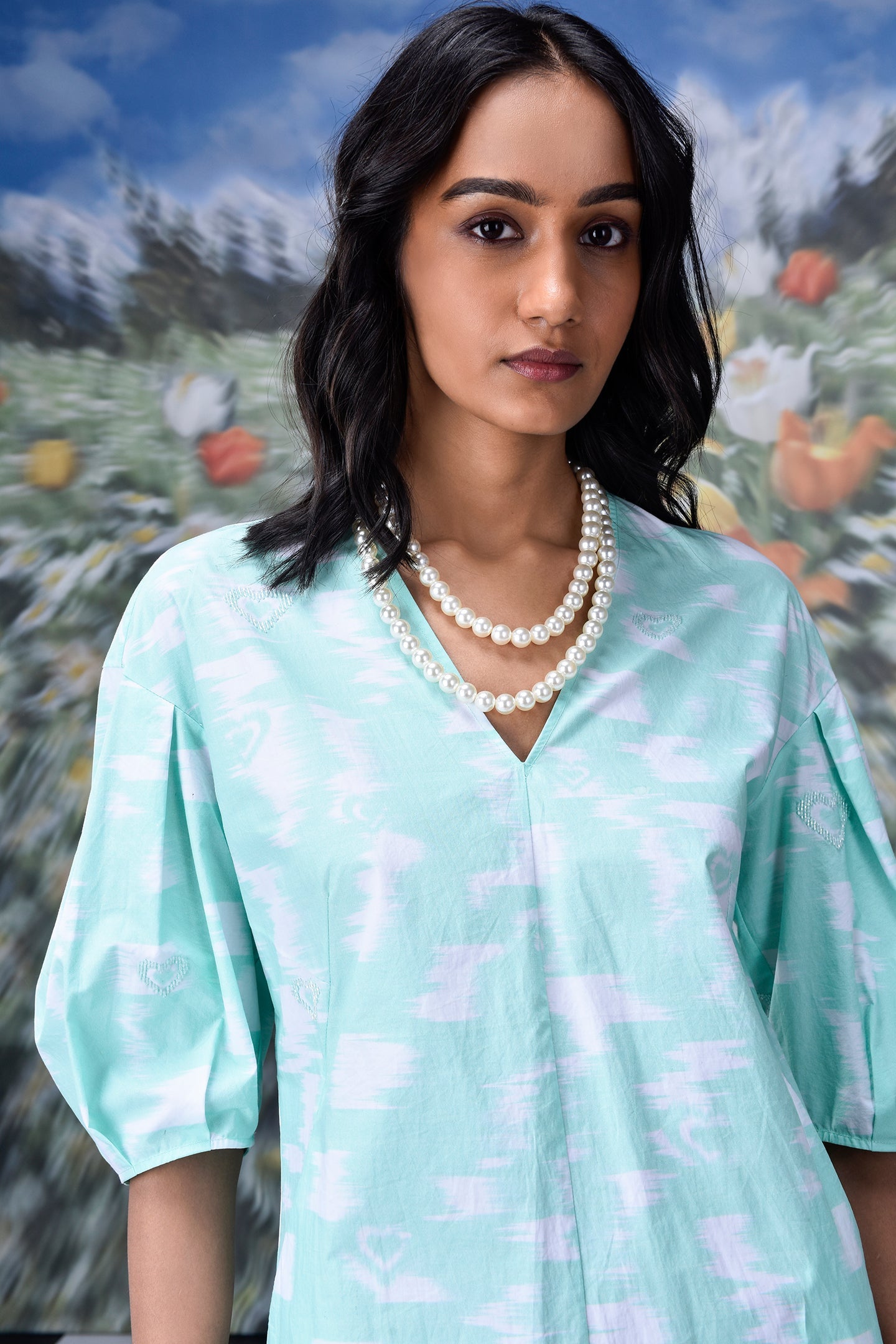 Stylera model wearing mint ikkat check dress V neck puff sleeves layered pearls women's ikkat check casual dress