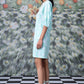 Model wearing Stylera women's ikkat check casual dress in mint knee length side profile with lace up sandals