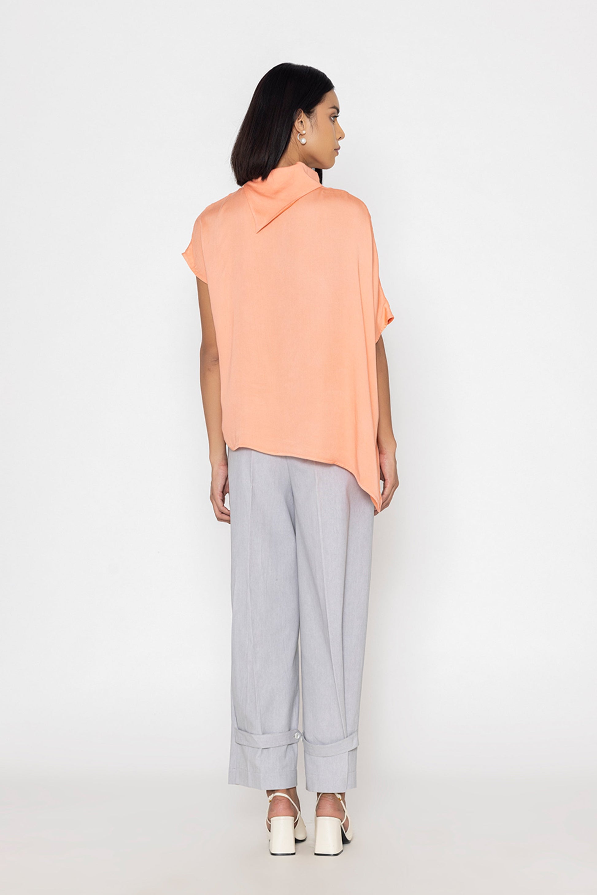 Stylera women's peach blouse with short sleeves and relaxed fit styled with gray pants