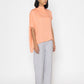 Stylera women's peach blouse with loose fit and high neckline styled with light gray pants