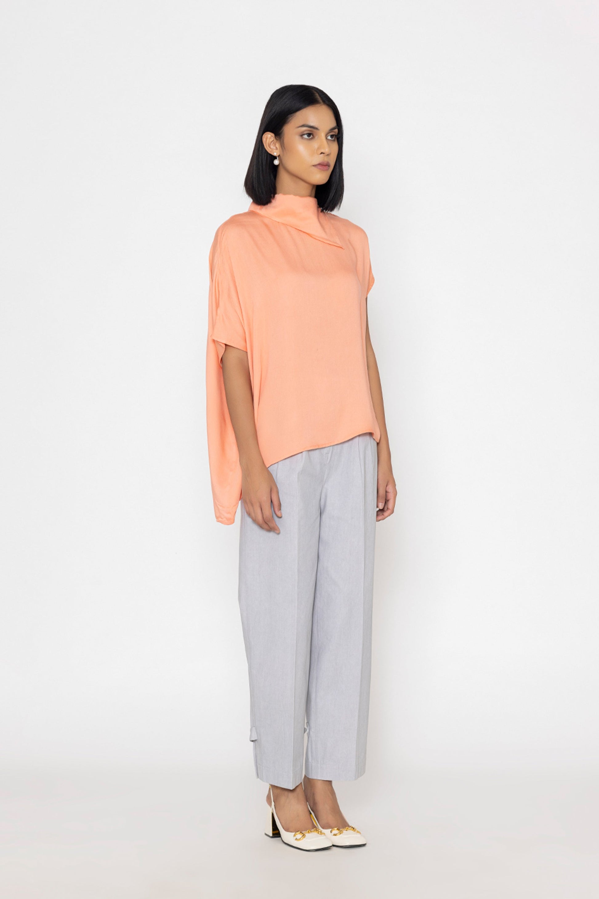 Stylera women's peach blouse with loose fit and high neckline styled with light gray pants