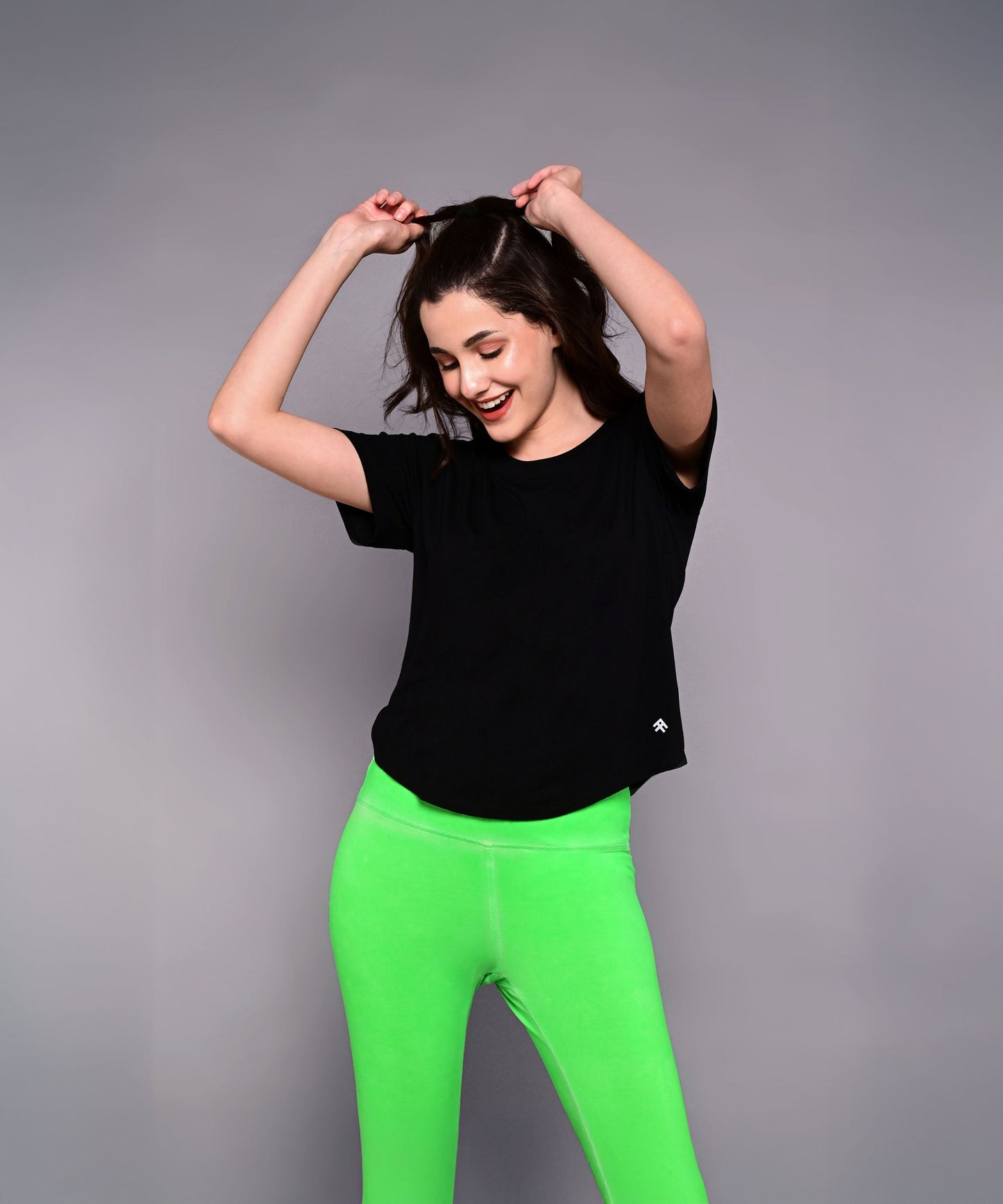 Black women's Pilates exercise top designed for comfort during workouts