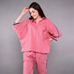 Stylish women's pink lounge set featuring a relaxed top and matching pants for comfort