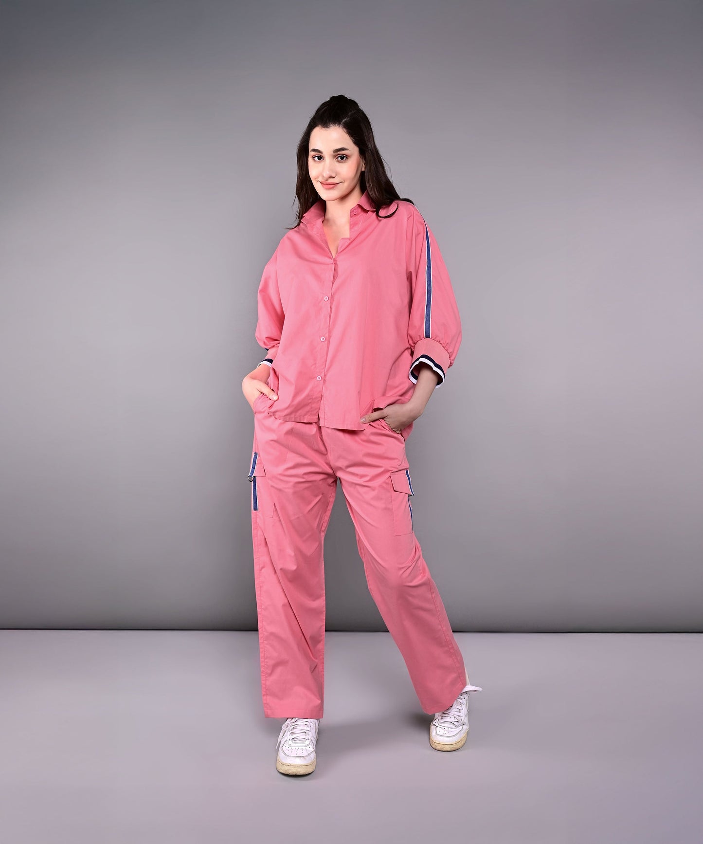 Women's pink lounge set featuring a relaxed fit top and matching pants with pockets