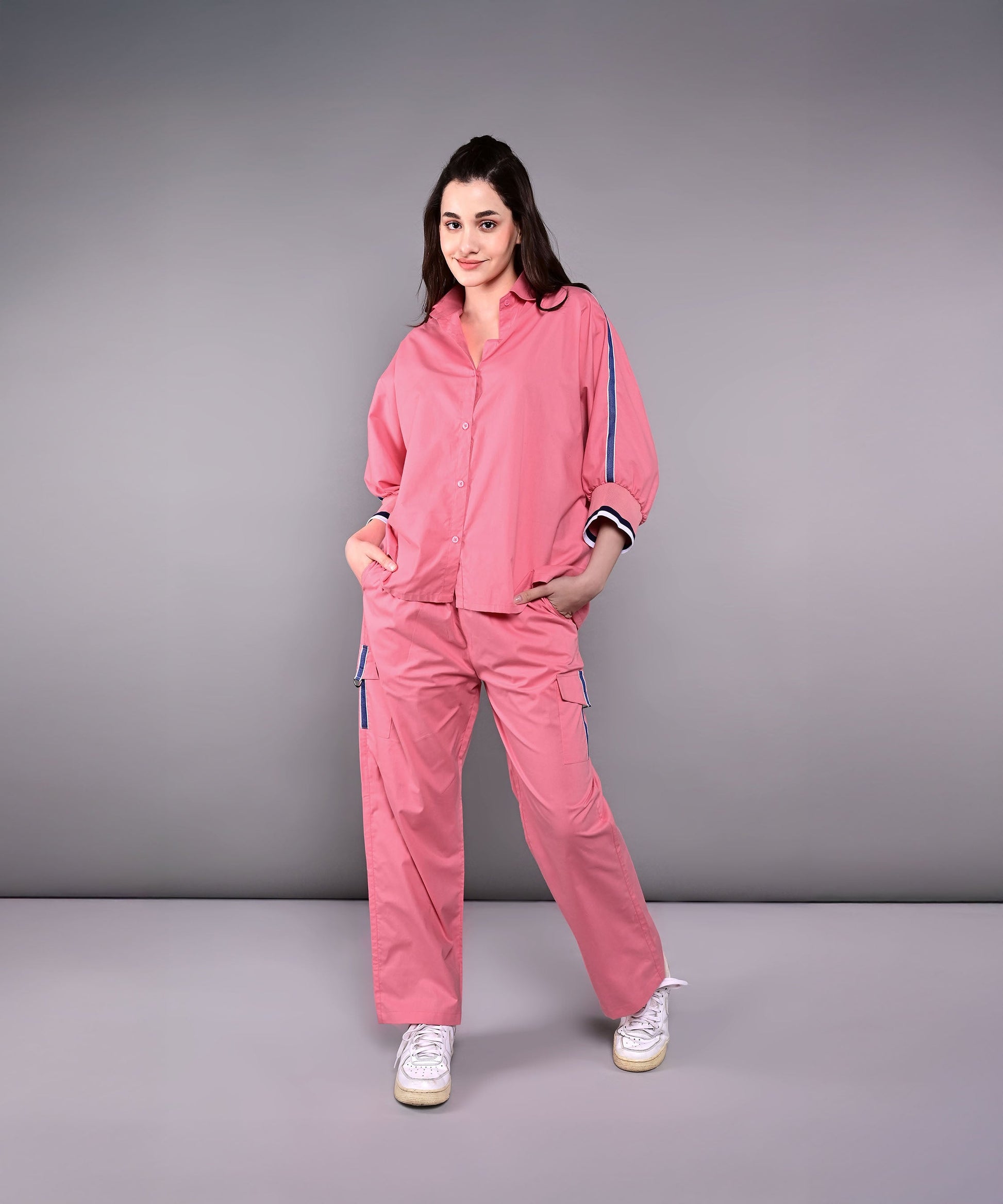 Women's pink lounge set featuring a relaxed fit top and matching pants with pockets