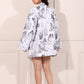Back view of a stylish women's printed blazer shorts set featuring an artistic black and white design.