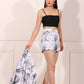Model wearing women's printed blazer shorts set with scalloped hem and floral design for a chic summer look