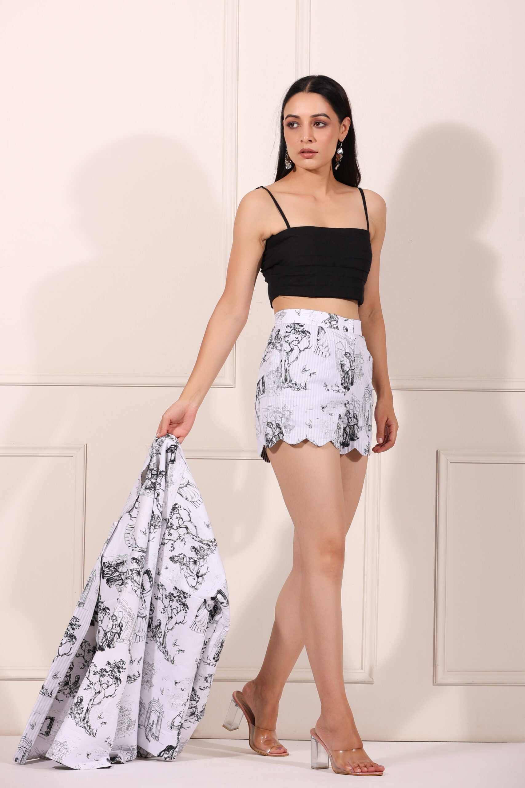 Model wearing women's printed blazer shorts set with scalloped hem and floral design for a chic summer look