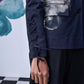 Close-up of Stylera women's statement blazer for work with lace-up sleeve detail in navy blue