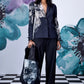 Stylera women's statement blazer for work in navy with floral print worn with matching pants and tote bag