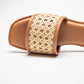 Close-up of Stylera women's summer flat sandals with woven beige strap and tan sole