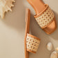Stylera women's summer flat sandals with woven rattan strap and tan sole on beige background