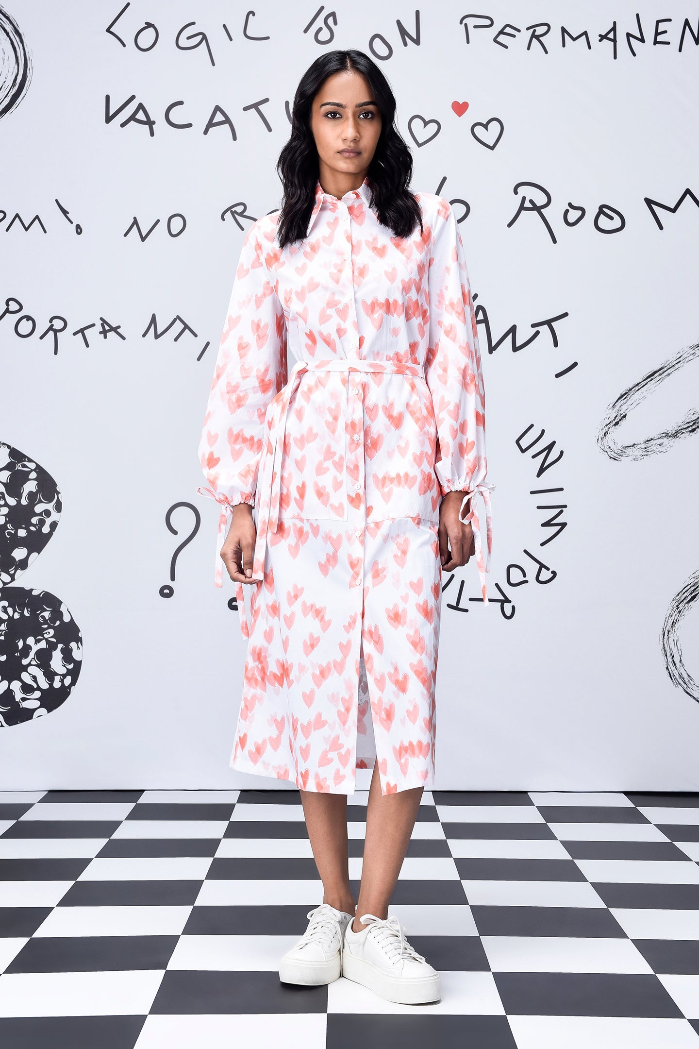 Model wearing women's trendy peach dress by Stylera collared long sleeve midi with tie waist and white sneakers