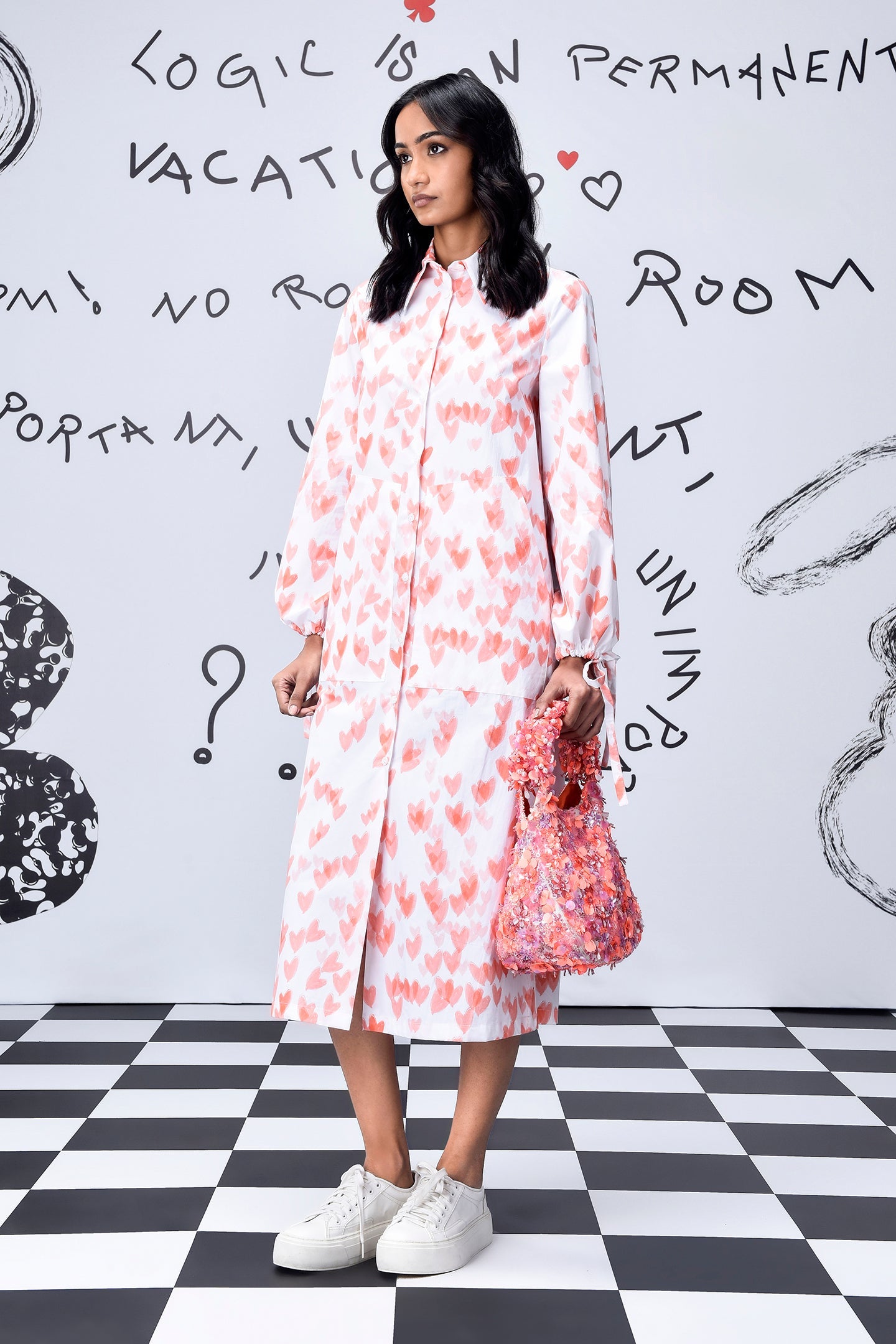 Stylera model wearing women's trendy peach dress midi with white sneakers and pink bag