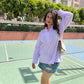 Stylera women's trendy summer tops in lavender, styled with denim shorts on a sunny day