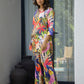 Model wearing a women's vibrant nightwear set featuring colorful tropical prints and stylish design