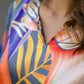 Close-up of women's vibrant nightwear set with colorful floral design and elegant neckline