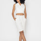 Stylera women's white vest top styled with matching white shorts and sneakers