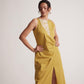 Stylera yellow draped midi dress with sleeveless design and front slit worn by a model