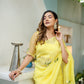 Elegant yellow floral organza saree from Stylera, styled with intricate floral embroidery and a light texture