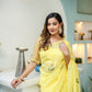 Elegant yellow floral organza saree draped elegantly with intricate embroidery for a stylish look