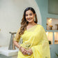 Elegant yellow floral organza saree with intricate embroidery, perfect for festive occasions