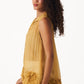 Stylera yellow organza sleeveless shirt with floral detailing on hem worn by model